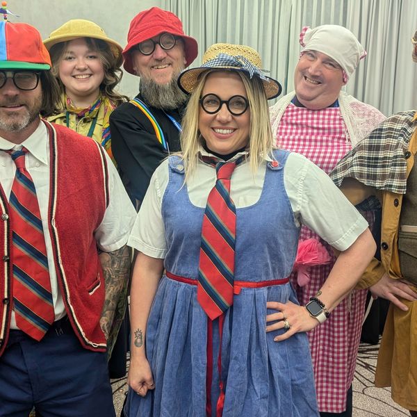 The six costumed suspects at an Engagement Unlimited Murder YOU Mystery corporate holiday party