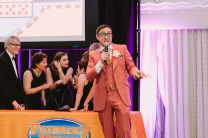 Family Friendly Feud host leading a corporate team through the game show