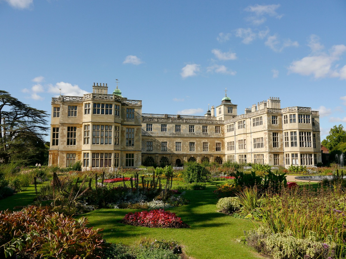 big white house in gardens and blue sky