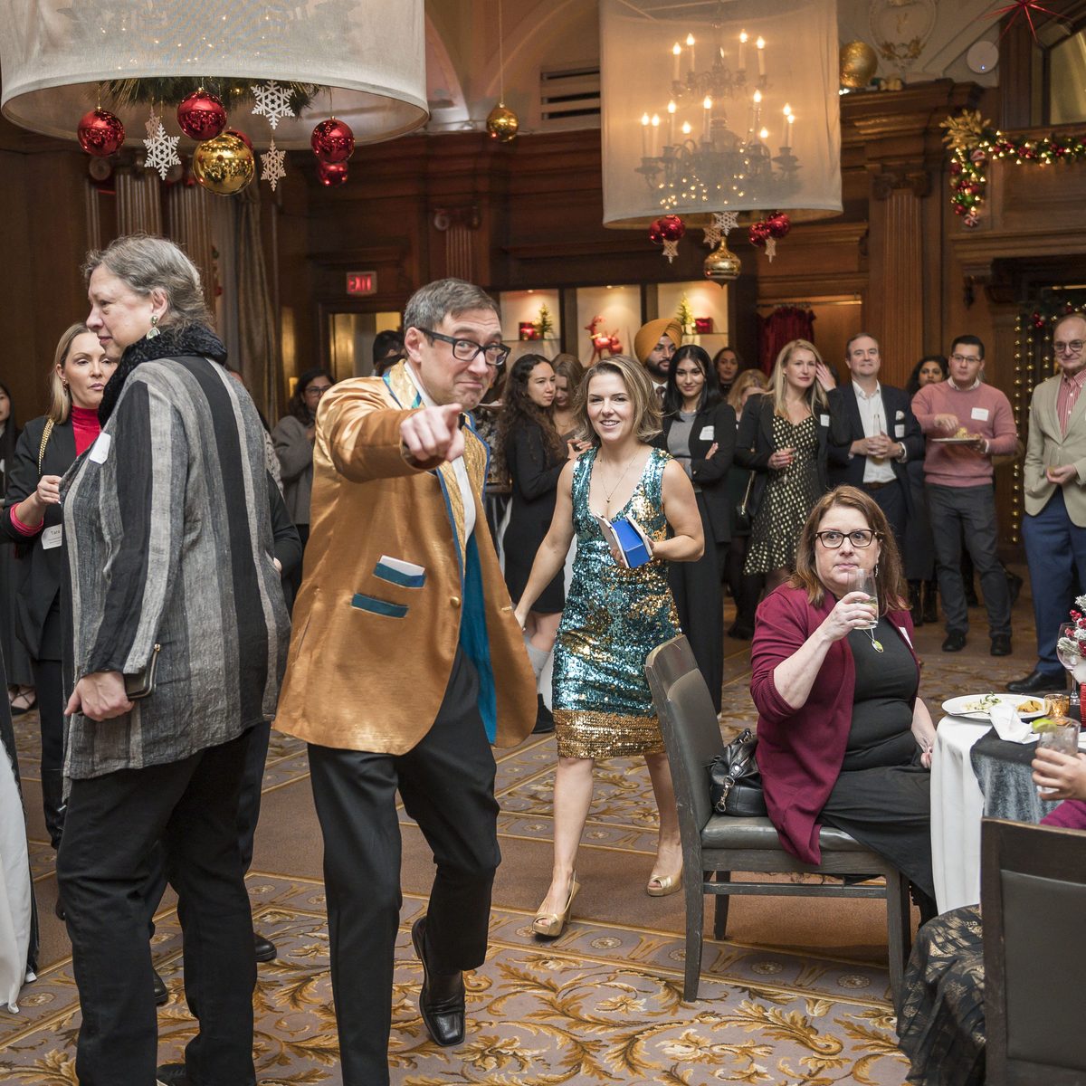 Prize Patrol host engaging a crowd and the reception table at a corporate holiday party